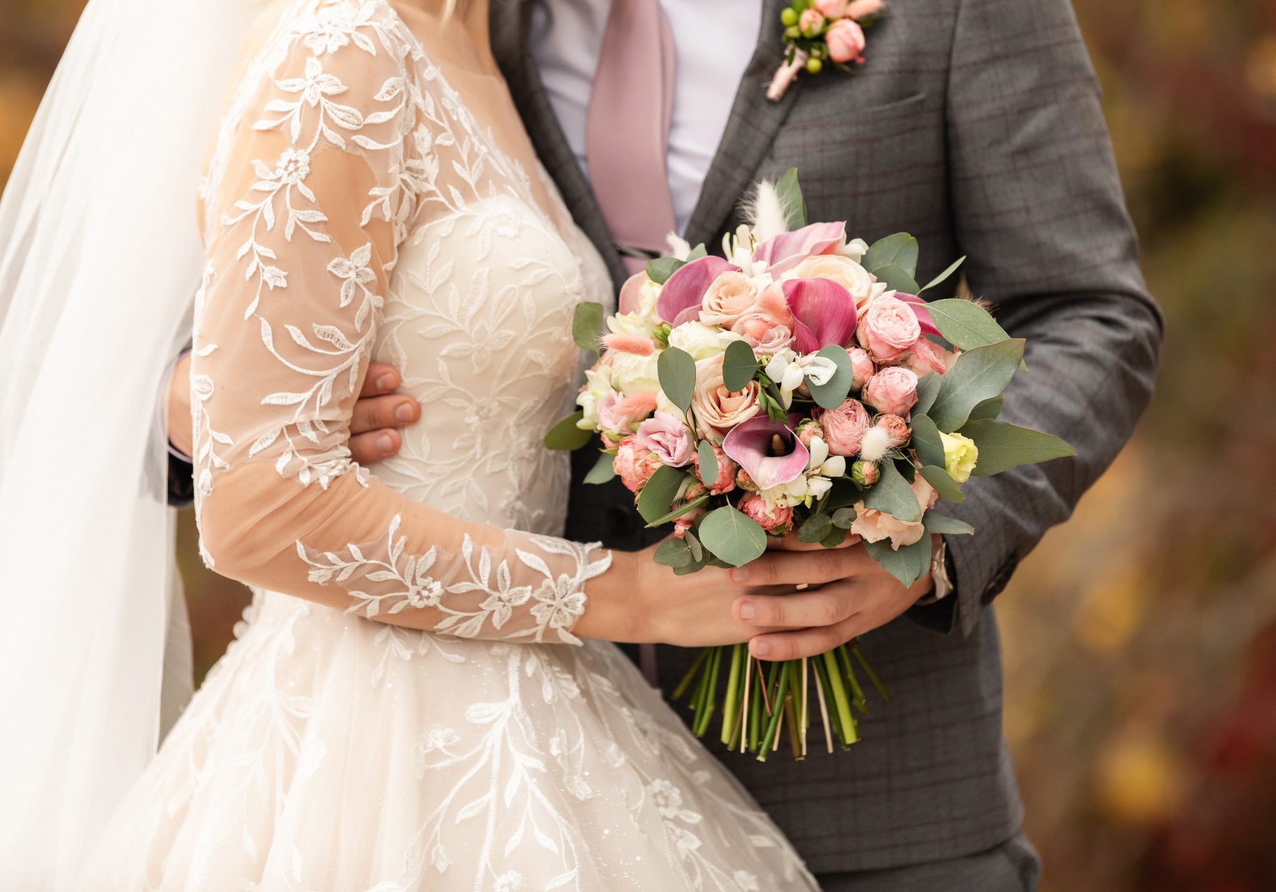 Newlyweds at wedding day, wedding couple with wedding bouquet of flowers, bride and groom